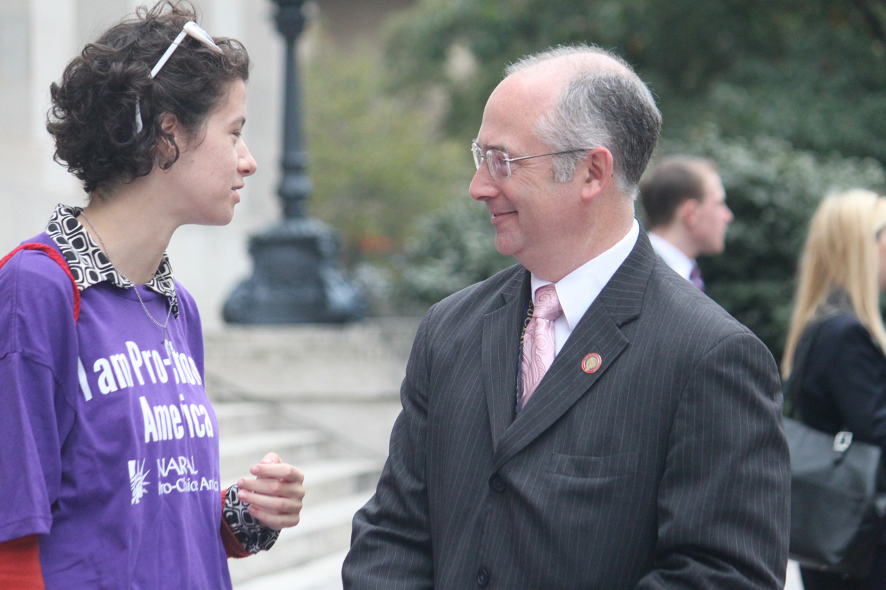 Rep. Smith speaking with constituent at women's access to healthcare news conference