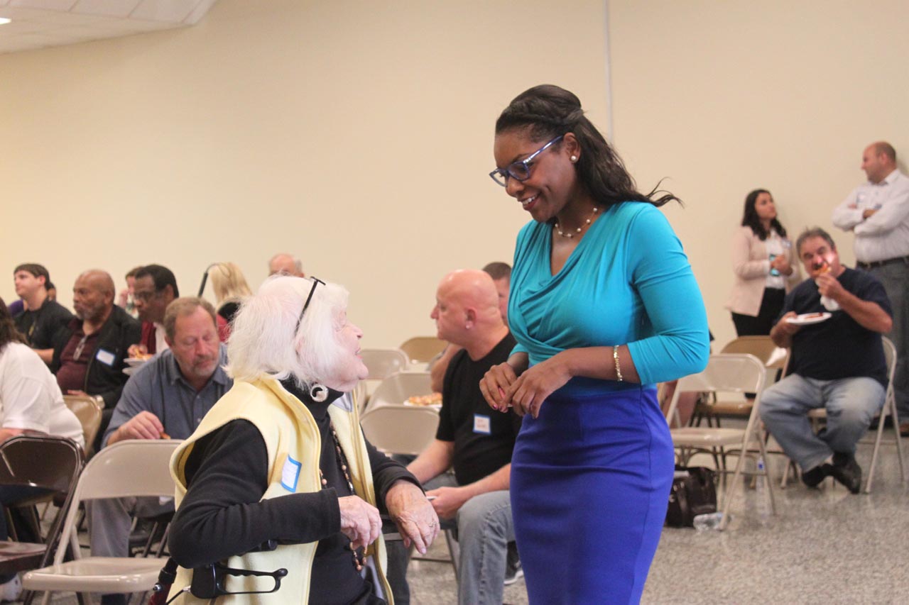 Rep. Sykes speaking with a constituent at a town hall meeting in Akron