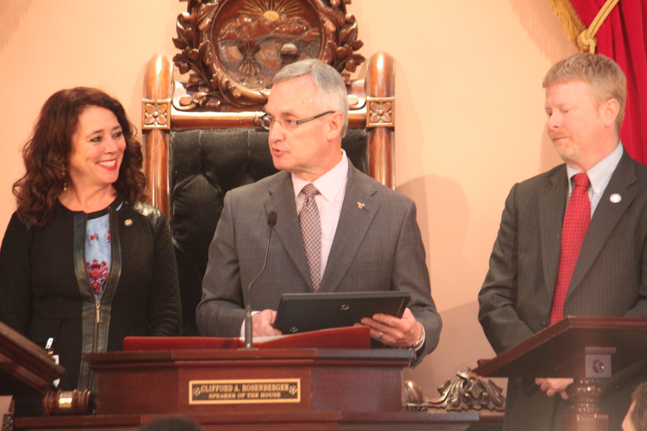 Rep. Lepore-Hagan presenting Jim Tressel with a House Resolution congratulating him for induction into the College Football Hall of Fame