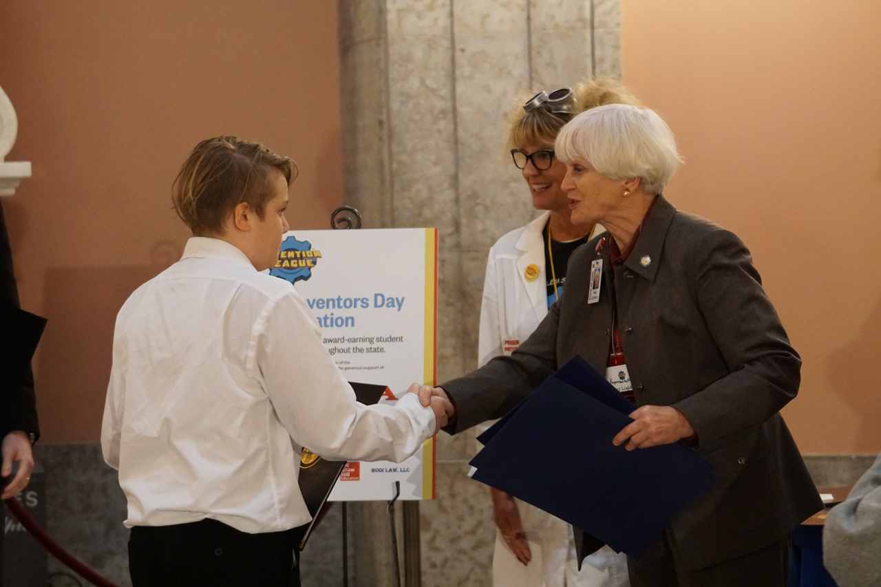 State Representative Mary Lightbody presents commendations to students participating in Kid Inventors Day at the Statehouse