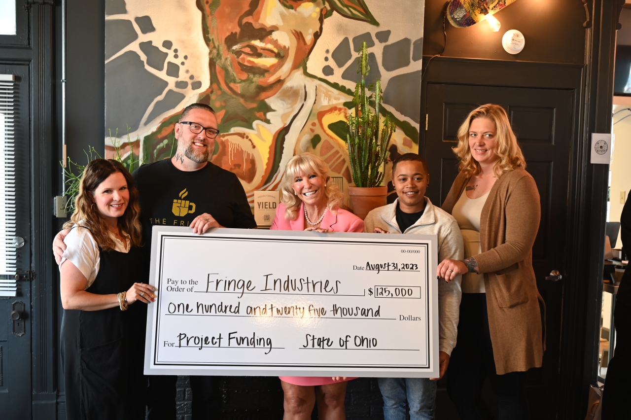 Representative Carruthers presents check to the Fringe.