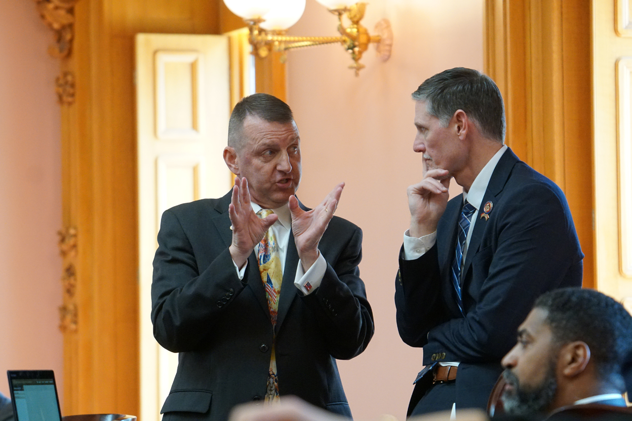 Rep. Miller speaks with Rep. Adam Miller (D-Columbus) before House session