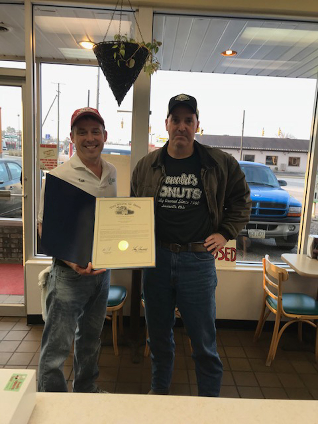 Rep. Holmes smiles alongside Donald's Donuts owner Tom Warne. Rep. Holmes presented Mr. Warne with a commendation for the businesses' 60th anniversary.