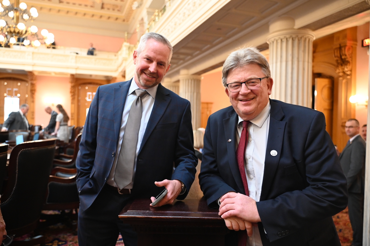 State Rep. LaRe smiles alongside State Rep. Jim Hoops before House session.