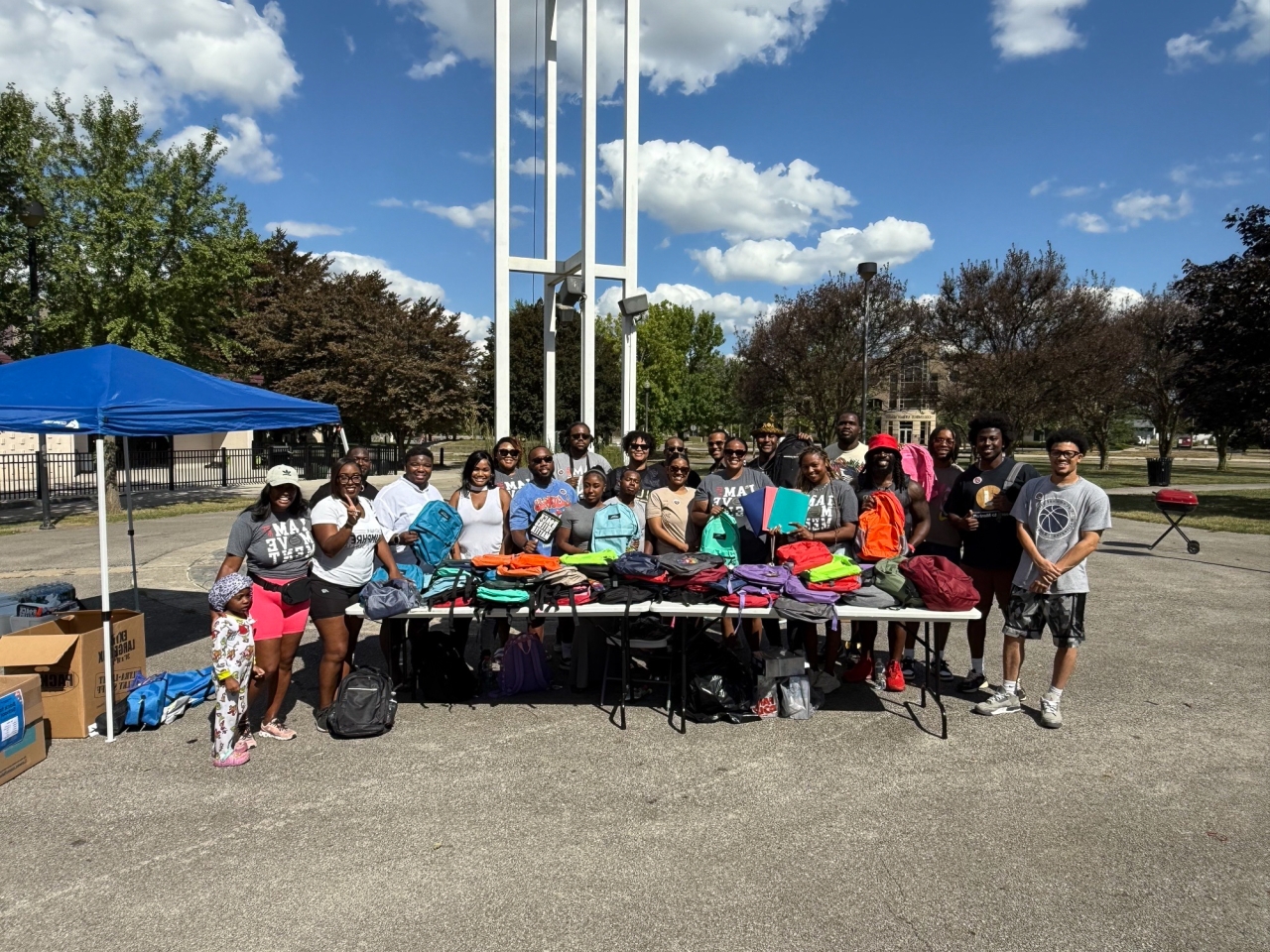 Community members pass out bookbags and other school supplies with Rep. Jarrells.