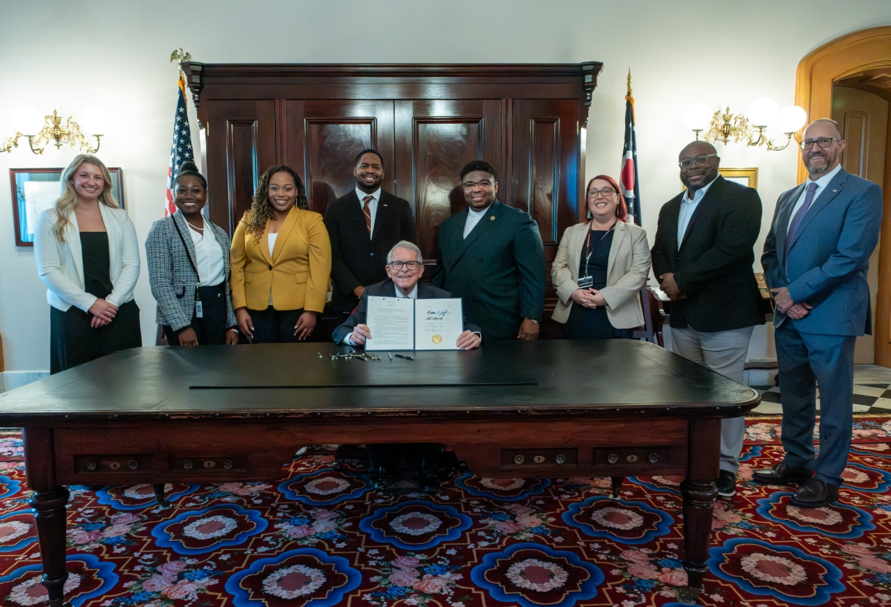 Rep. Jarrells and advocates with Governor DeWine signing House Bill 57 into law.