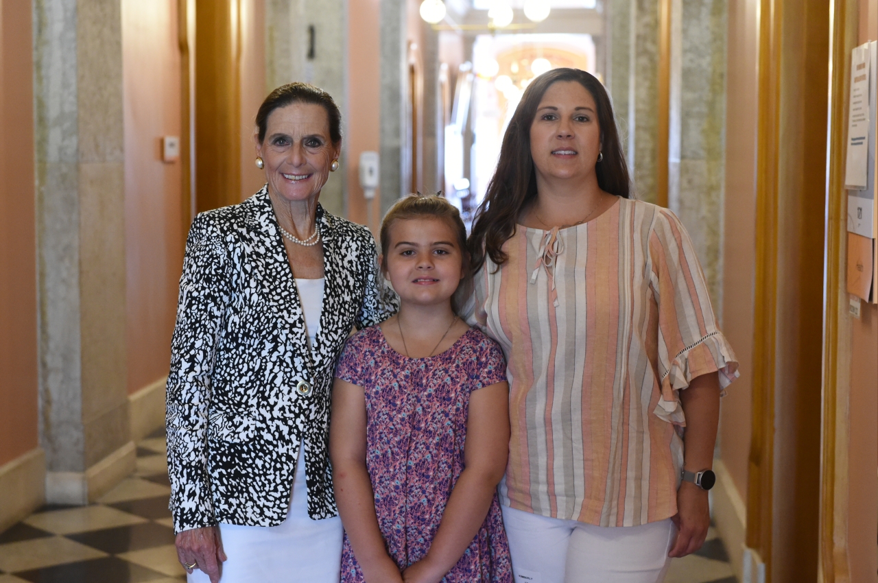 Rep. Schmidt stands with Makenna Day and Kim Manion after giving testimony on Makenna's law in the House Health Committee.