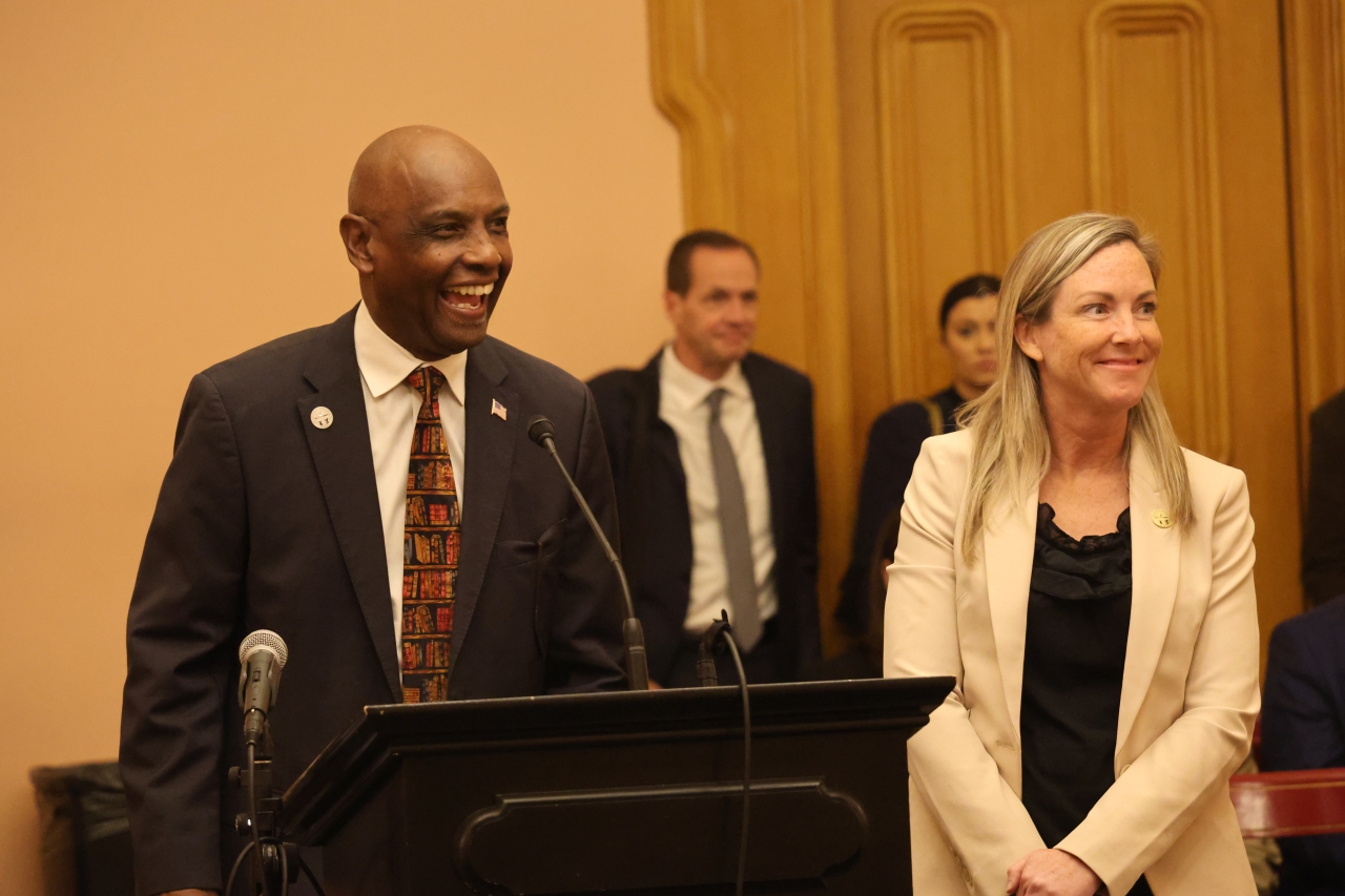 Rep. Thomas giving sponsored testimony in committee with Rep. Baker