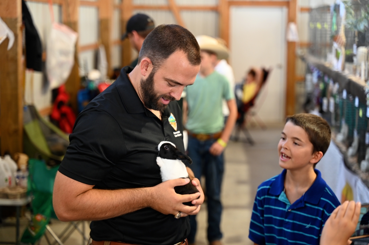 Rep. Adam Mathews holds a bunny at the Warren County Fair