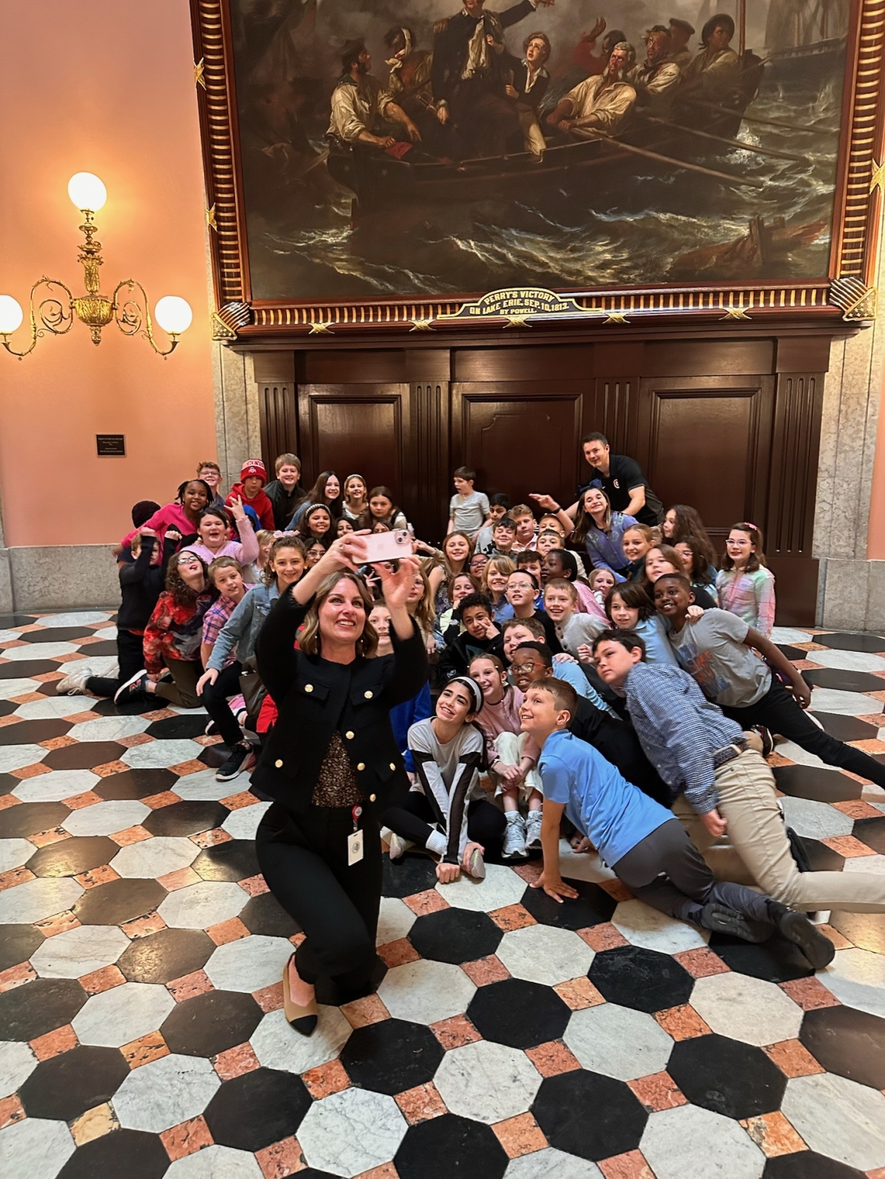 Rep. Lett taking a photo with students from her district